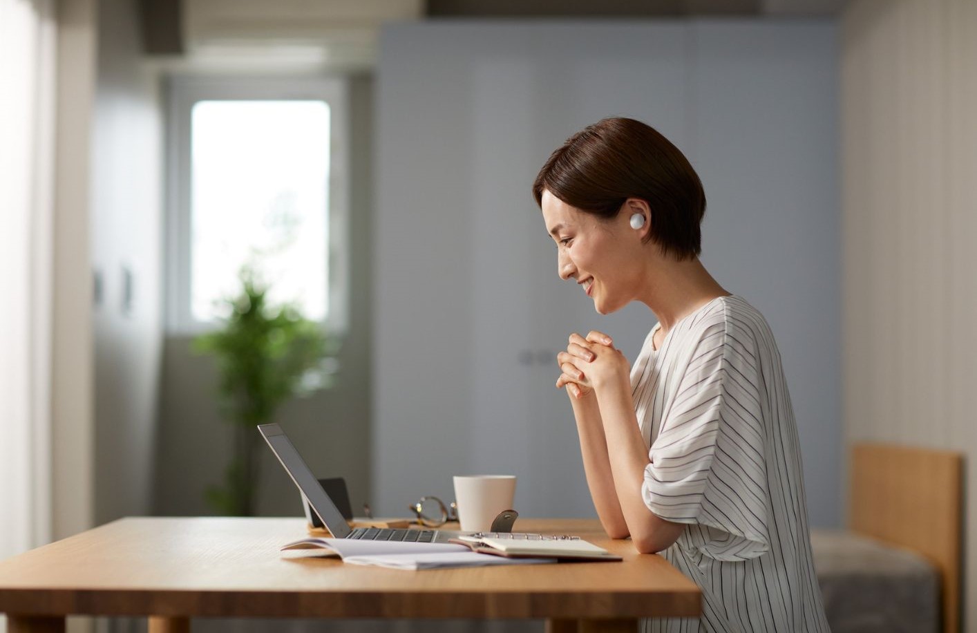 a focused student at her computer studying online