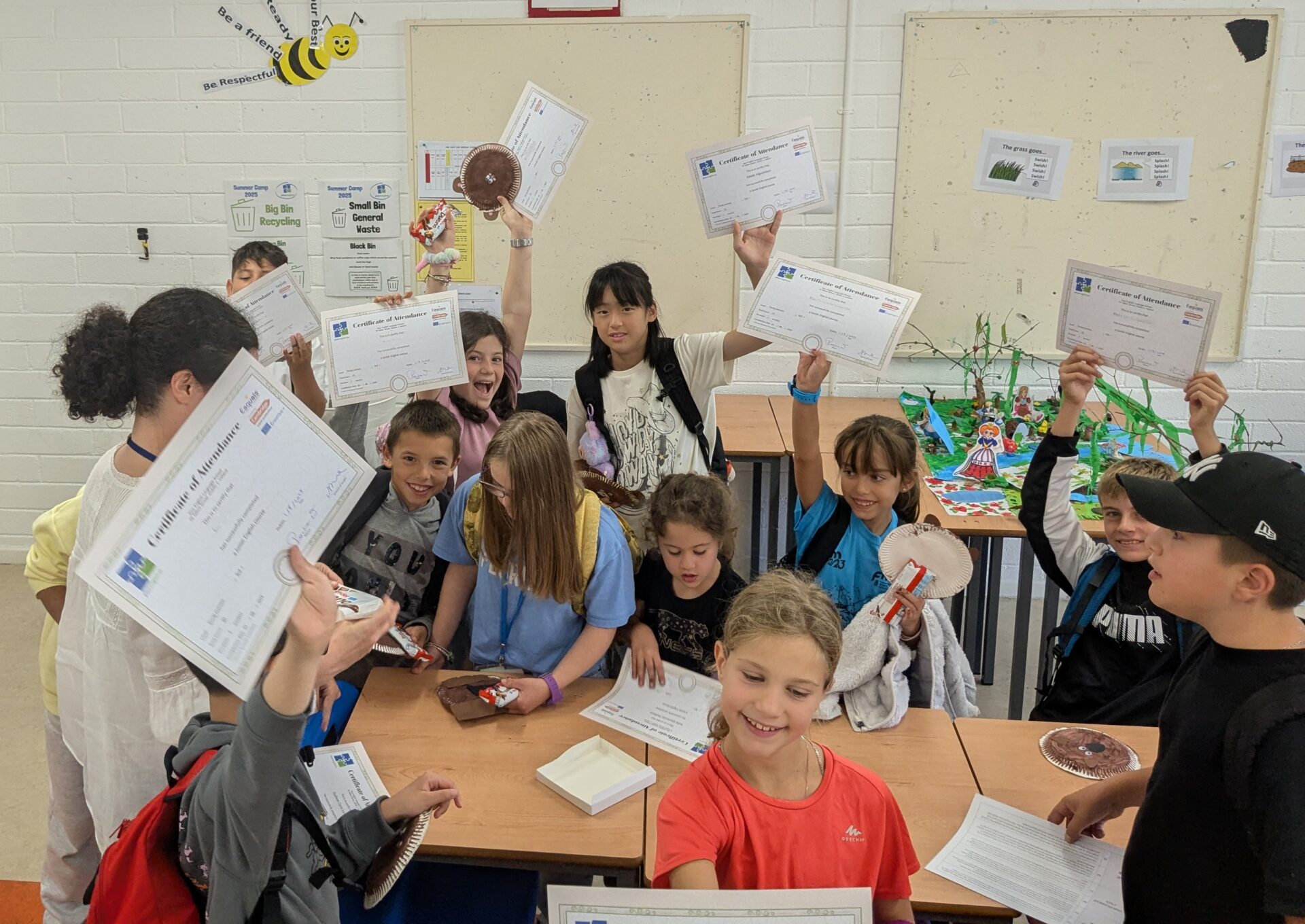 Children show their Enlgish course completion certificates towards the end of the classes